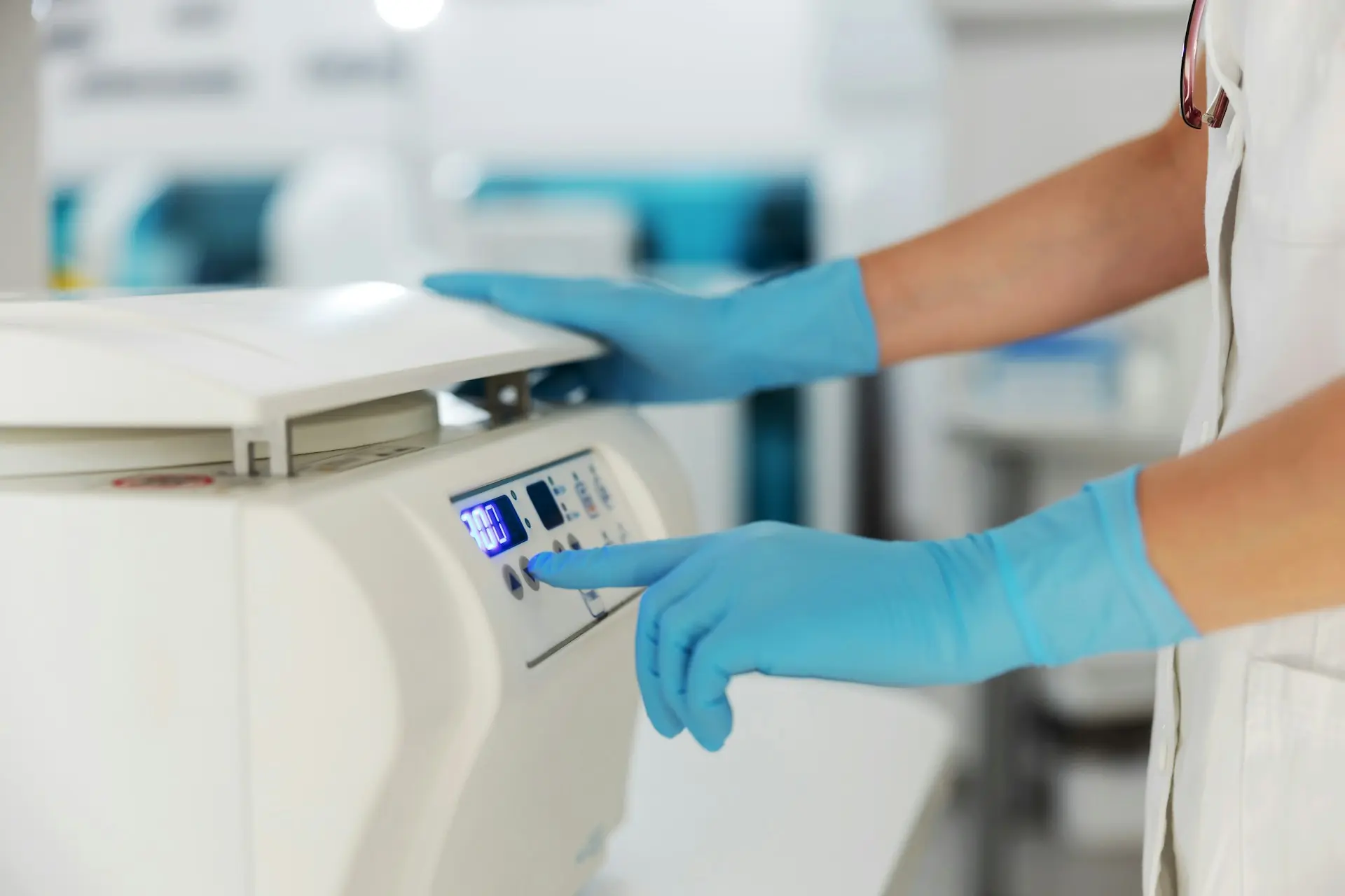 Lab technician operating equipment for analytical method development in pharmaceutical testing